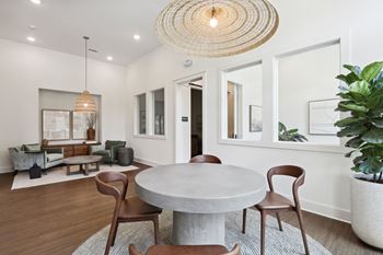 A modern dining room with a round table and chairs at Arcadia Cartersville Apartments, Cartersville, GA